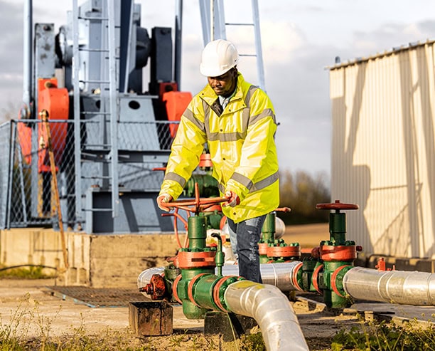 Oilfield Worker Operating Valve Safety Jacket Pipeline